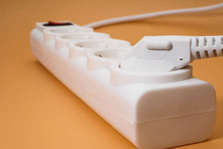 Closeup of electrical plug plugged in power stripの写真素材