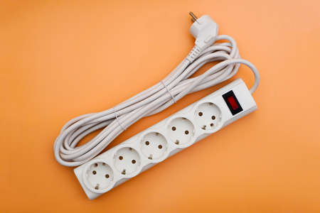 Top view on power strip with neatly coiled electrical cord
