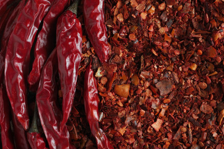 top view on ground dried chilli pepper flakes and whole chilli podsの写真素材