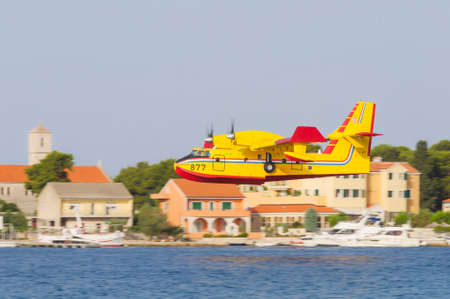 SIBENIK, CROATIA, August 6 2012 - Bombardier 415 Superscooper (Canadair cl-415) scooping water in...