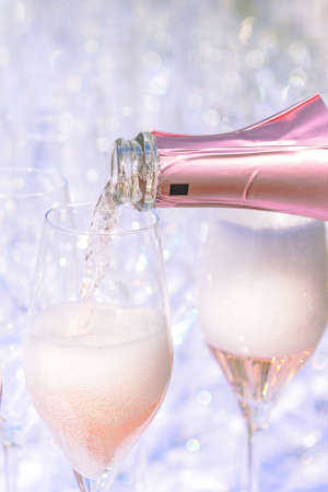 Pouring champagne into glasses, no people