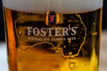 Close up of a glass of Foster's with foamのeditorial素材