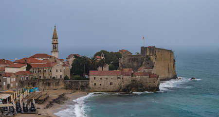 A rainy morning in Budva provided a unique and clear view over the old town with Sv. Ivan church and city citadel with fortified walls without seeing the usual mountains in the background, that were hidden behind the rain curtainのeditorial素材