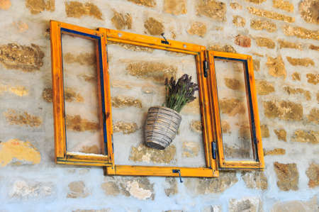 Lavender bunch in pot, in wooden frame and serving as wall decorationの写真素材
