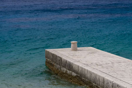Traditional stone pier and blue sea in backgoundの写真素材