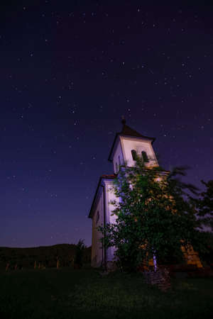 Church in clear, starry night with Ursa Maior - Big bear to the left and Polaris - North star to the rightの写真素材