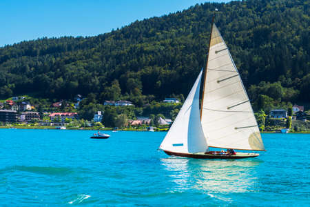 Vintage wooden sailboat on lake, sailing on Worthersee, Carinthia, Austriaの写真素材