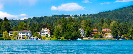 Worthersee lake, Austria - August 14 2016: luxury villas on shore of beautiful alpine lake Worthersee in summer. This is most popular lake in Austria among tourists.のeditorial素材