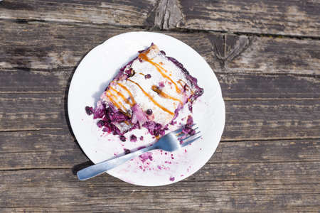 Blueberry pie strudel Close up shot on white plate on old woodの写真素材