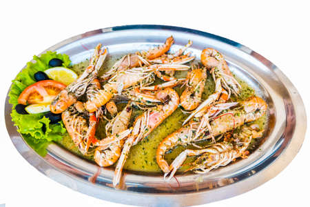 Cooked Scampi Prawns Shrimps in white wine sauce with garlic and parsley, closeup, isolatedの写真素材