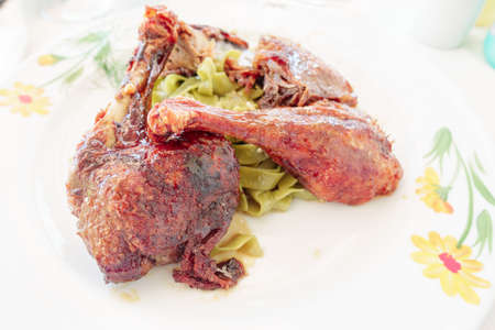 Roasted Duck leg, stewed with honey and ginger with green noodlesの写真素材