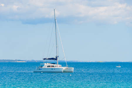 Luxury sailing catamaran in open seaの写真素材