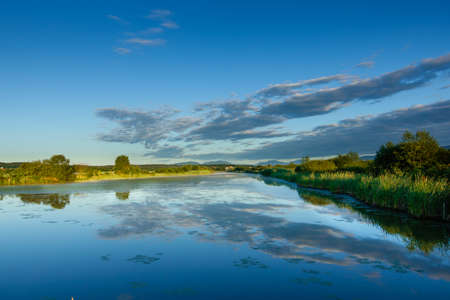 Lake landscape early in the morning with clouds