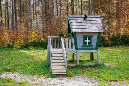 Wooden fairytale treehouse, playing house on children playground with stairs and climbing wall