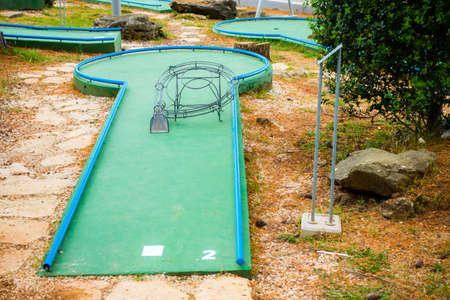 Mini golf course with obstacles, green field