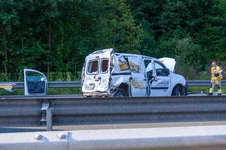 Blagovica, Slovenia - August 28 2018: Slovenian Post Van damaged in car accident on Styrian Highway A1 near Blagovica, Fireman walking toward the vehicle. The A1 is one of busiest highways in Slovenia.のeditorial素材