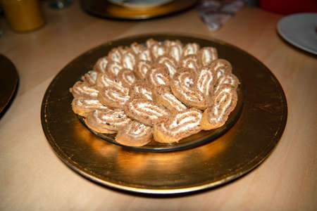 Christmas yule log, buckwheat dough and cream filling on golden decorative plateの写真素材