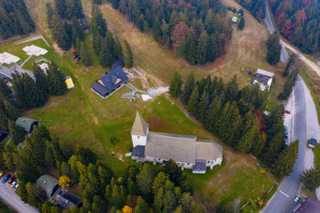 Aerial view of mountain resort in summer, Trije kralji on Pohorje, Slovenia with cabins, ski slopes and a churchの写真素材