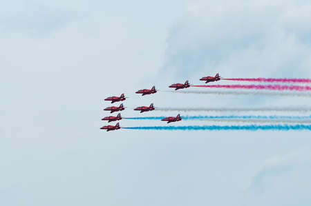 Maribor, Slovenia - June 3 2011: Red Arrows Aerobatic Display Team performing at public airshow in Maribor. The Red Arrows are the official display team of Royal Air Force. Free admittance to show.のeditorial素材