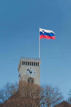 Tower of Ljubljana castle with Slovenian flag flying above the towerの写真素材
