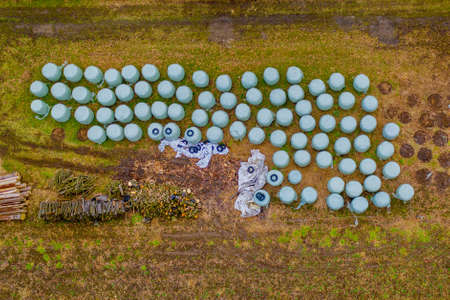 Bale silage on meadov, aerial view, gren bales with fodder for livestockの写真素材