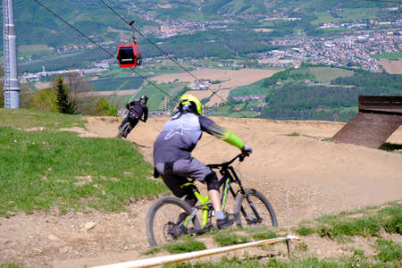 Maribor, Slovenia - May 2, 2019: Downhill mountain bikers riding down the trail on Pohorje near Maribor, Slovenia. Pohorje bike park is very popular with riders.のeditorial素材