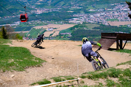 Maribor, Slovenia - May 2, 2019: Downhill mountain bikers riding down the trail on Pohorje near Maribor, Slovenia. Pohorje bike park is very popular with riders.のeditorial素材