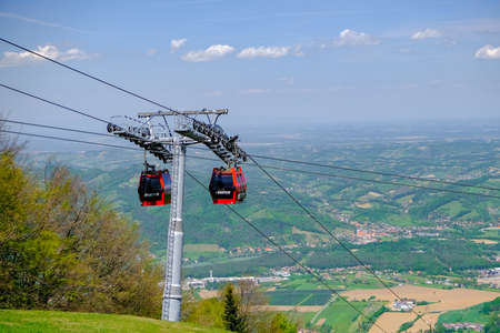 Maribor, Slovenia - May 2 2019: Red cabins of the Pohorska vzpenjaca cable car in Maribor, Slovenia connect the top of Pohorje mountain with the cityのeditorial素材