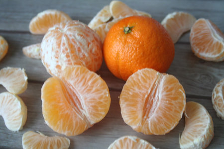 Orange and orange slices on a dark background close-upの写真素材