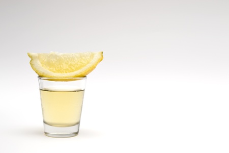 Tequila shot with lemon wedgeの写真素材
