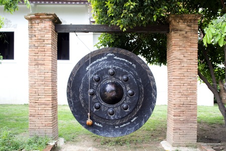 Old round asian gong within temple groundsの写真素材