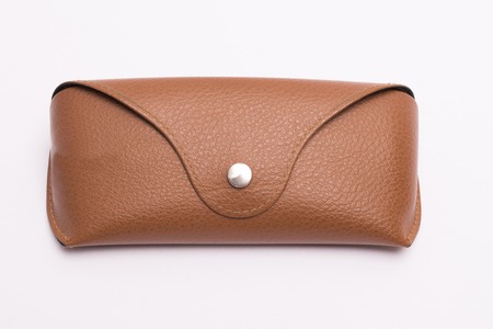 Brown textured leather sun glasses case on a white backgroundの写真素材