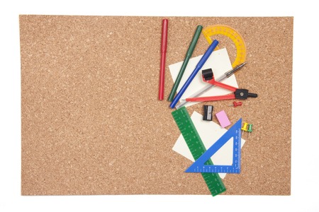 Cork board background with various coloured stationary