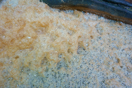 Nature Orange Brown Bubble Foam from Waterfall. Texture Pattern Background.