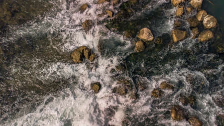 small waterfall in the riverbed of the Segura River, seen from a drone from an overhead shot in Murciaの写真素材
