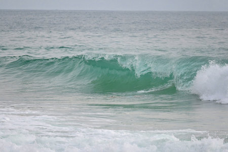 A powerful crystal green ocean wave on a beautiful beach, Phuket, Thailand.の写真素材