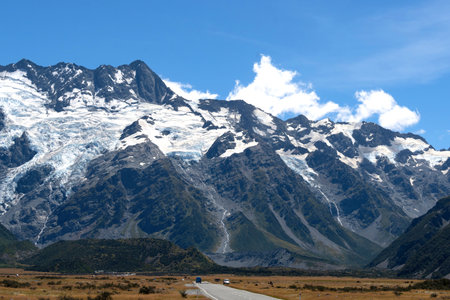 A beautiful view of a route leading to one of the most famous destination for tourist, Mount Cook National Park, in a peaceful summer day, New Zealand.の写真素材