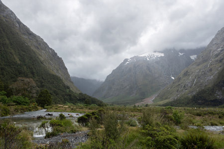 A journey in Valley of a Thousand Waterfalls in a foggy day, Milford Sound, New Zealandの写真素材