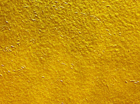 Shiny yellow leaf gold foil texture background.
