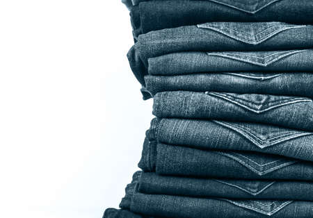jeans stacked isolated on white background.の写真素材