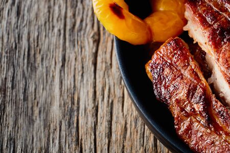 Medium grilled barbecue steak with pepper and various spices, top view
