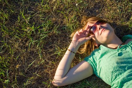 Woman lying in grassの写真素材