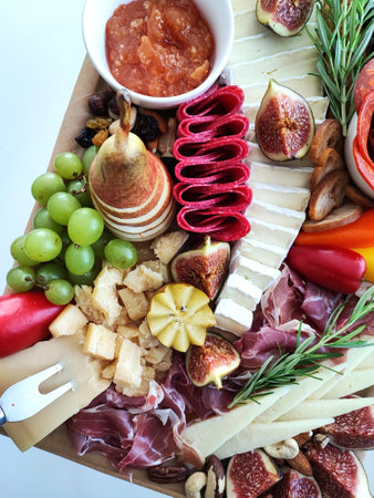 Charcuterie board, Antipasto platter with prosciutto crudo or jamon, figs, grape and wineの写真素材