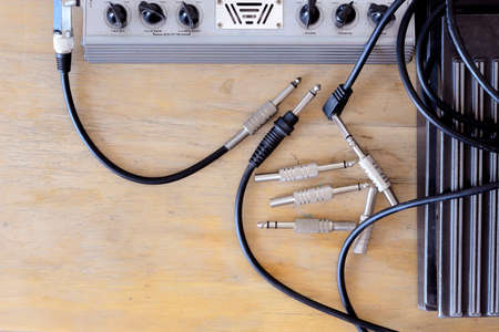 old guitar multi effects device  and volum pedal on wood backgroundの写真素材