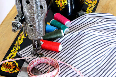 Close up image of sewing machine with colored threads and sartorial meter の写真素材