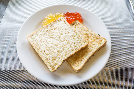 Bread butter and jam orange marmalade strawberry and berry.
