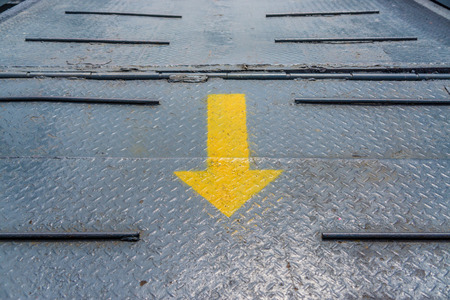 Arrow sign pointing forward on  roadの写真素材