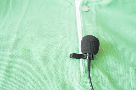 Close-up of  holding a Wireless lavalier microphoneの写真素材
