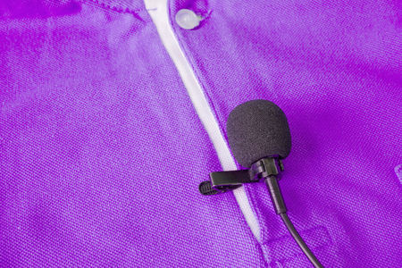 Close-up of  holding a Wireless lavalier microphoneの写真素材