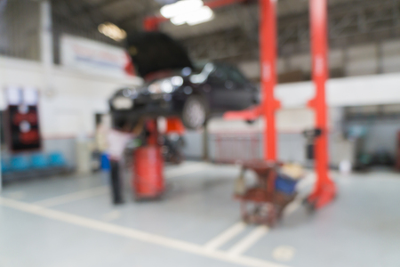 Blurred of car technician repairing the car in garage background.の写真素材